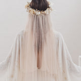 Bride wearing a long soft English tulle veil and floral crown for a dreamy ethereal bridal look